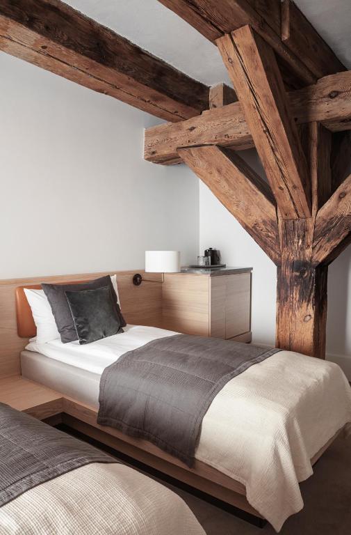 a bedroom with a large bed with wooden beams at Copenhagen Admiral Hotel in Copenhagen