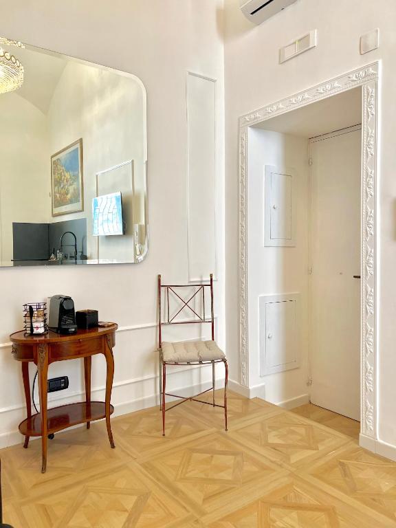 a mirror in a room with a table and a chair at Fiorentine Relais in Naples