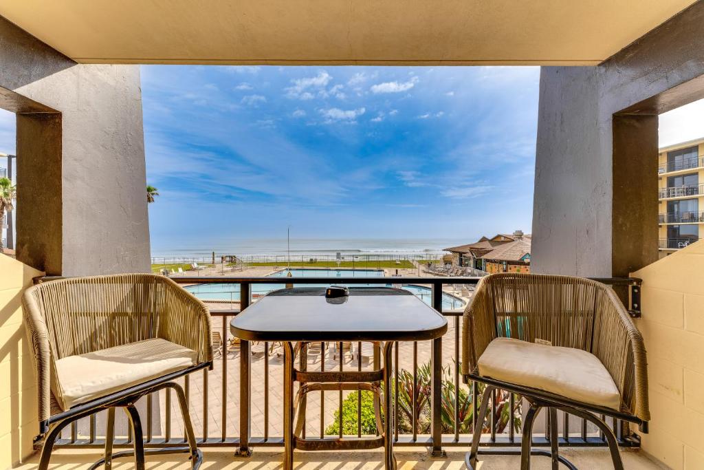 a balcony with two chairs and a table at Daytona Beach Resort Studio with Beach Access! in Daytona Beach