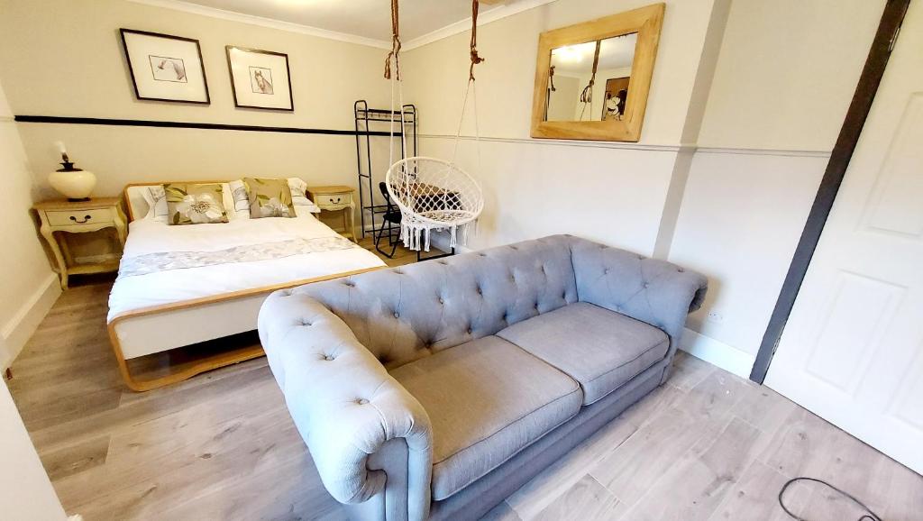 uma sala de estar com um sofá e uma cama em Scottish Nest in the heart of East Kilbride 10mins from Hairmyres Hospital em East Kilbride