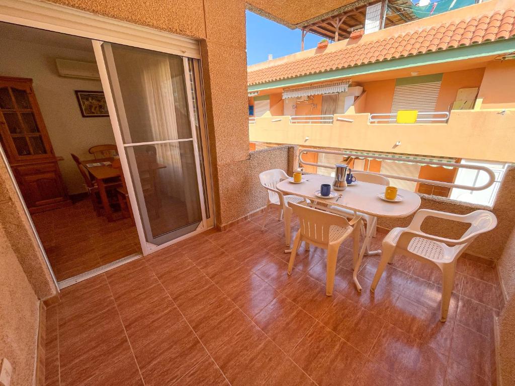 a room with a table and chairs on a balcony at Apartamentos Portofino 3000 in Oropesa del Mar