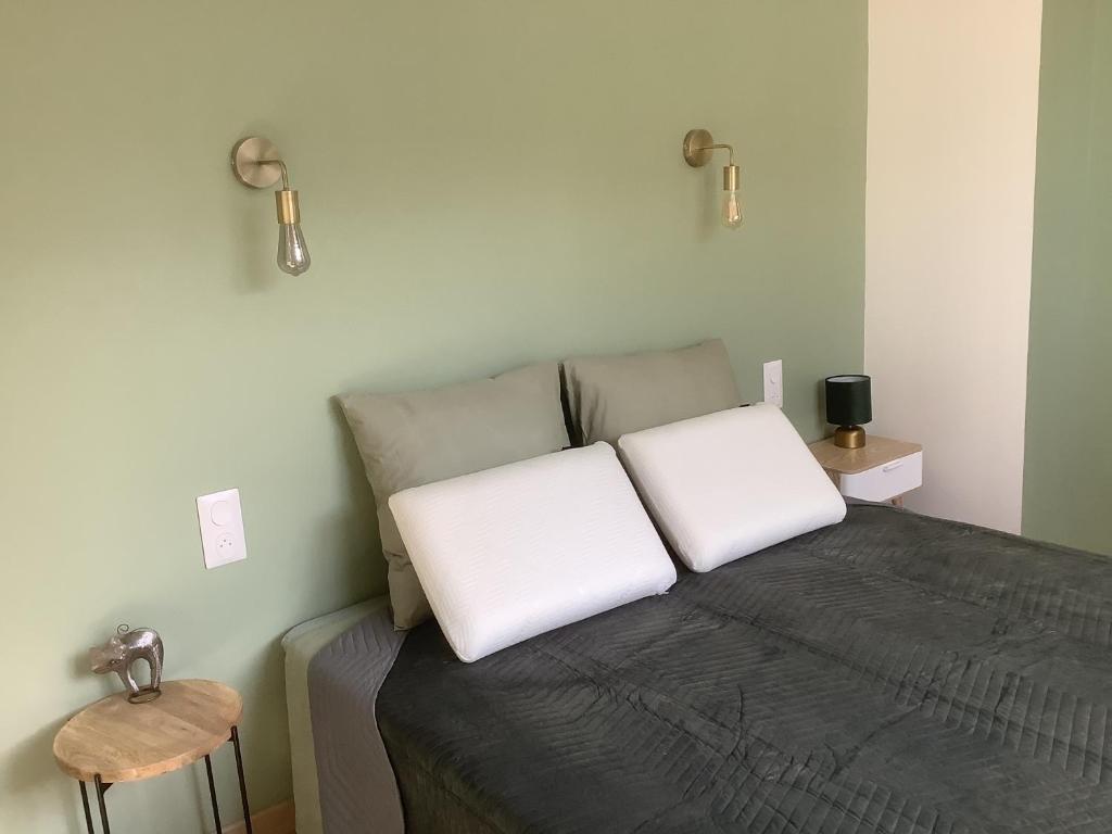 a bedroom with a bed with two pillows on it at Gîte de L’entre Deux in Upie