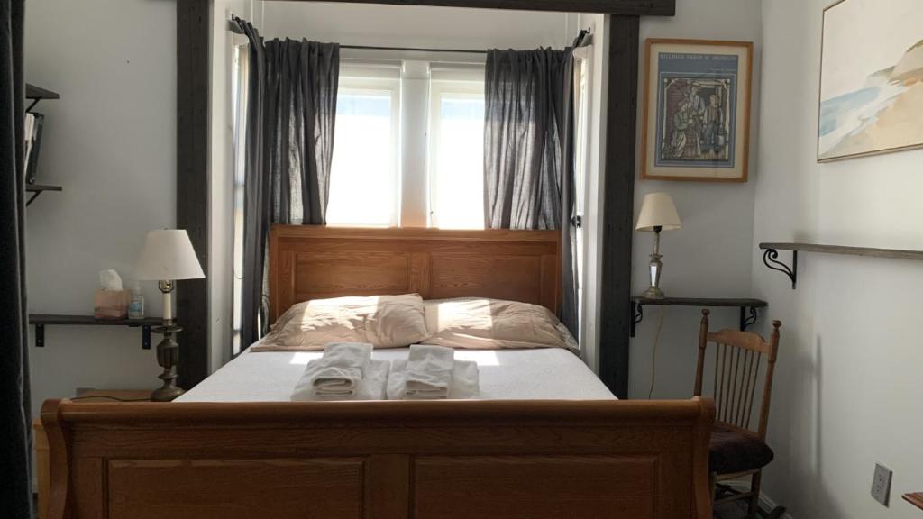 1 dormitorio con 1 cama con 2 toallas en Private Rooms, Shared Bath in a Private Home Minutes From Logan Airport, en Boston