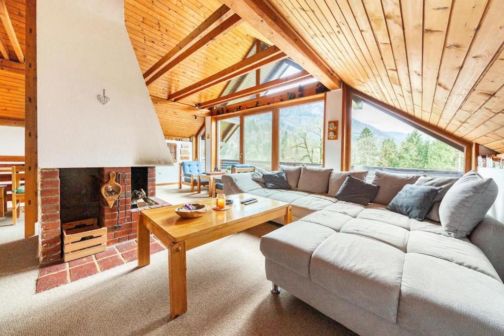 a living room with a couch and a fireplace at Holiday Home Bela in Bohinjska Bela