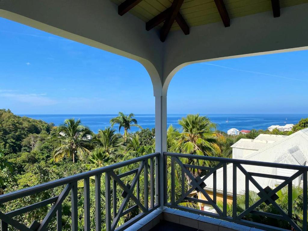 a balcony with a view of the ocean at Maison de 2 chambres avec vue sur la mer jardin clos et wifi a Gourbeyre a 1 km de la plage in Gourbeyre