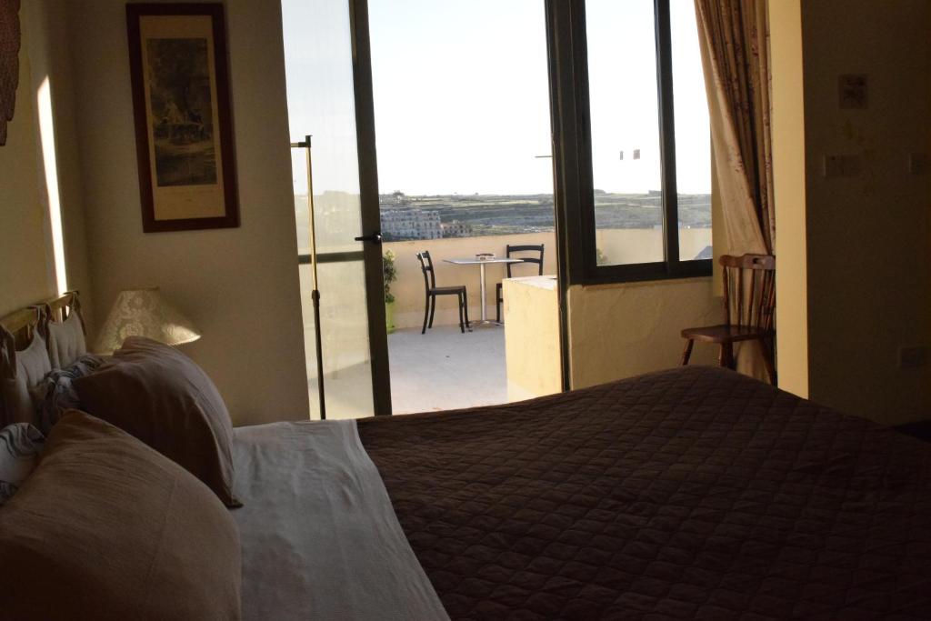 Katil atau katil-katil dalam bilik di Gmiel in-Natura B&B