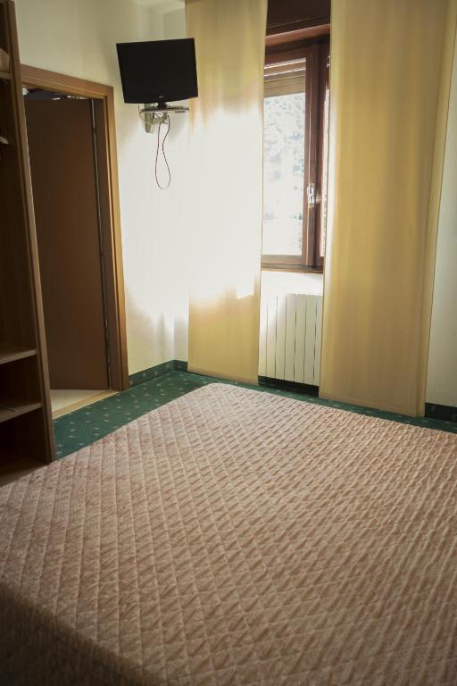 Postel nebo postele na pokoji v ubytování Albergo La Romanella