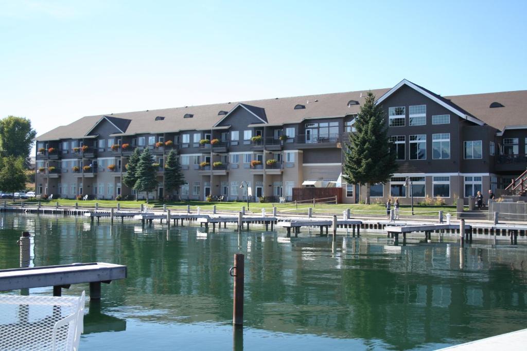 a large apartment building with a marina in front of the water at Kwataqnuk Resort & Casino in Polson