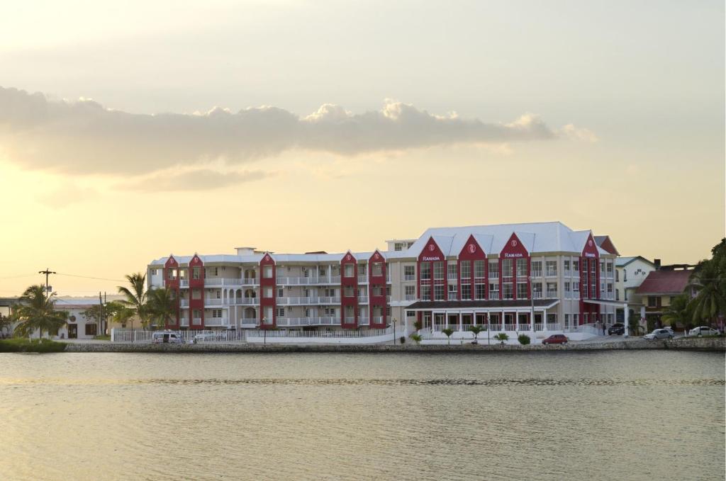 a group of buildings next to a body of water at Ramada by Wyndham Tikal Isla de Flores in Flores