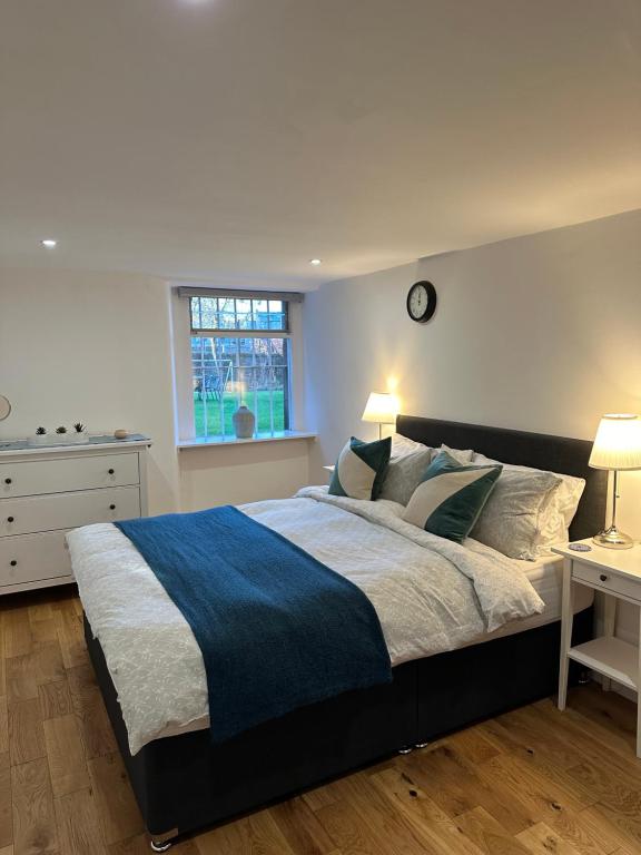 a bedroom with a large bed with a clock on the wall at The Inverleither in Edinburgh