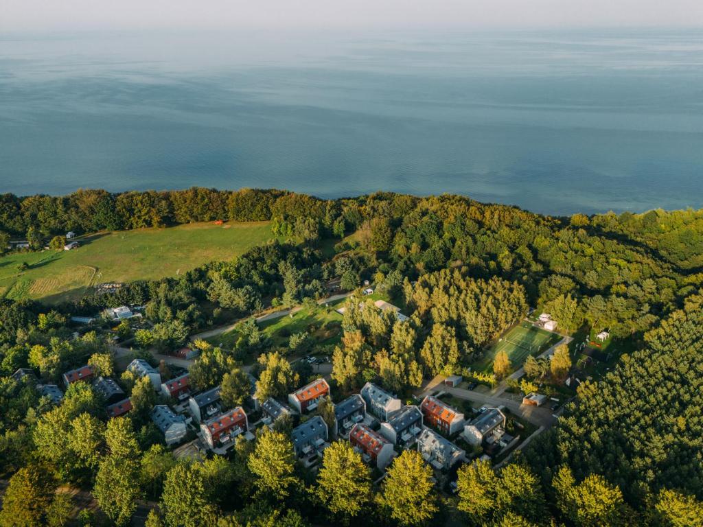 an aerial view of a house on a hill with trees at Rosevia Resort & Spa in Jastrzębia Góra