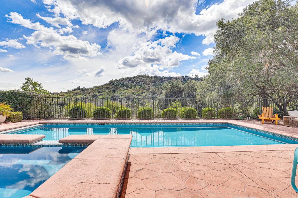 a swimming pool in a yard with a fence at Escondido Home Private Pool, 2 Grills and Fire Pit! in Escondido
