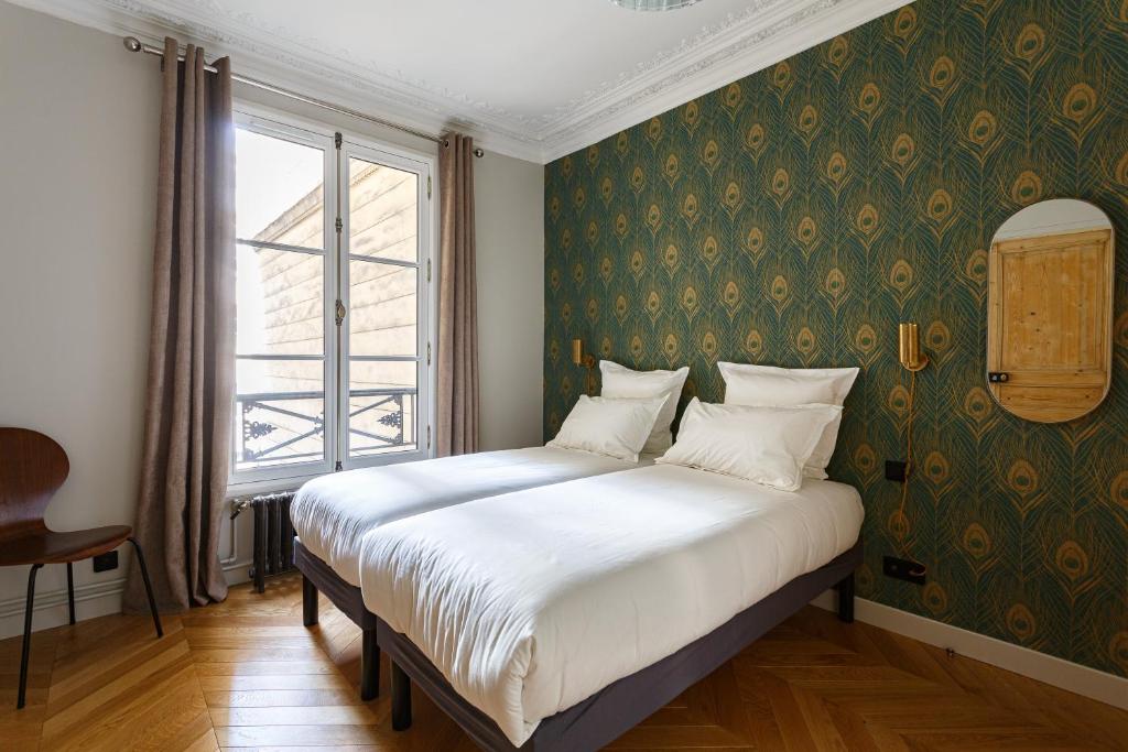 Un ou plusieurs lits dans un hébergement de l'établissement Stylish apartment in the heart of Paris