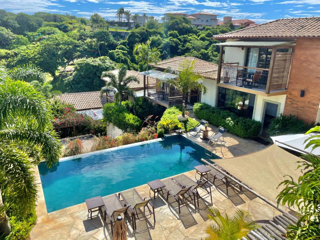 a swimming pool in front of a house at Pousada Villa Canaã in Búzios