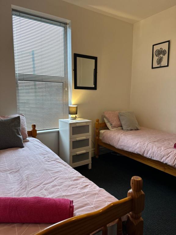 a bedroom with two beds and a window at Winter Gardens Flat 2 - Studio in Blackpool
