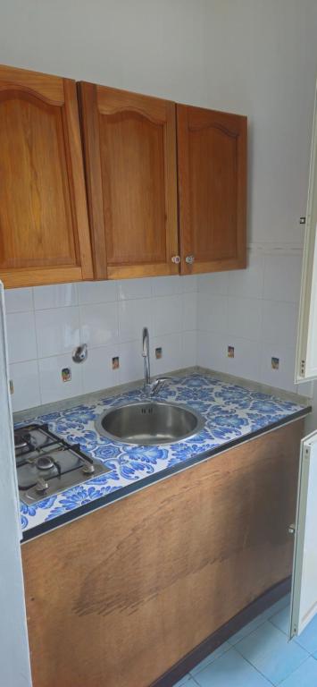a kitchen counter with a sink and a stove at Piccolo Tirreno Hotel Residence in Procida