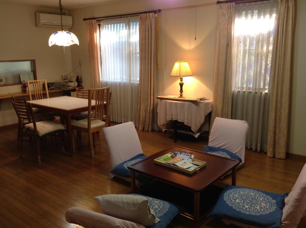 a living room with a table and a dining room at 8-17 Nomura Motomachi - House / Vacation STAY 1893 in Hirakata