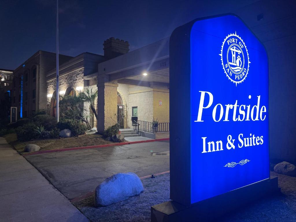 a sign for a princeton inn and suites at night at Portside Inn & suites in San Pedro