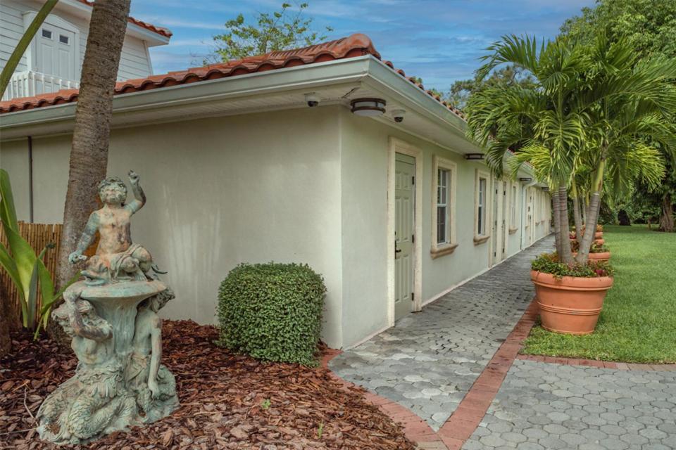a home with a statue of a woman on a fountain at Shangri-La Springs in Bonita Springs