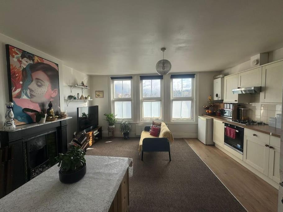 a living room with a couch and a fireplace at Comfy entire place for max 4. in London