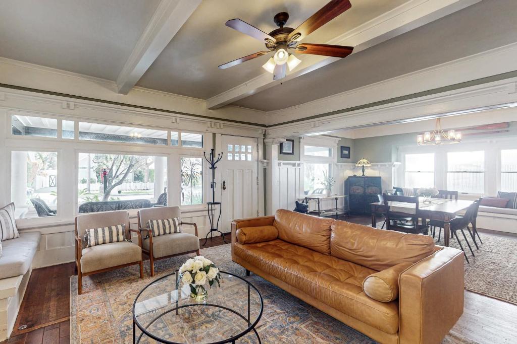 a living room with a couch and a ceiling fan at Old Yacht Club Inn in Santa Barbara