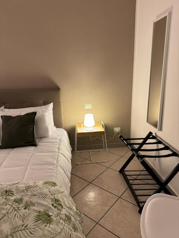 a bedroom with a bed and a yellow table at 4Th Floor Caserta in Caserta