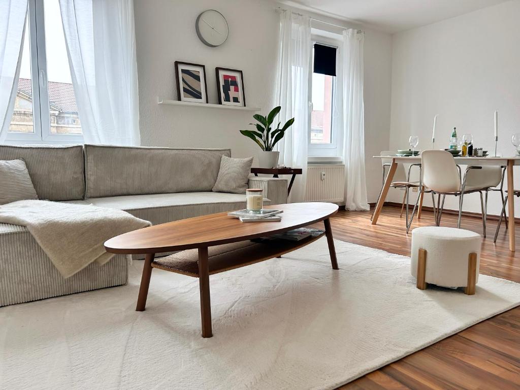 a living room with a couch and a coffee table at Spa Apartment am Bauhausmuseum in Dessau