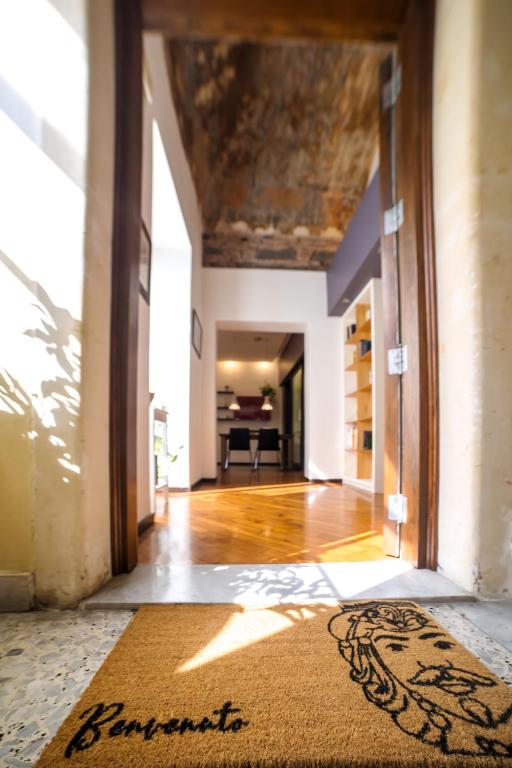 an empty hallway with a rug in the middle of a room at Zagara Luxury Home in Catania