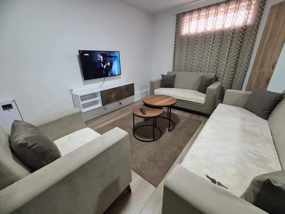 a living room with a couch and a table at Apartments Gjakove in Gjakove