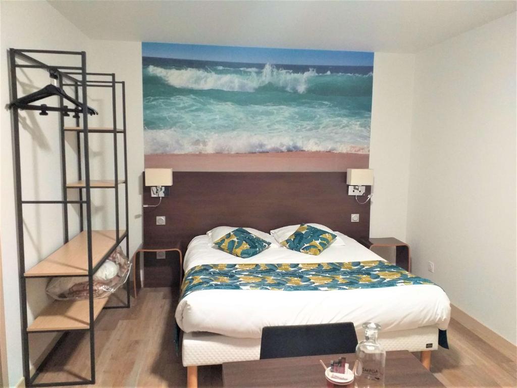 a bedroom with a bed and a painting of the ocean at Brit Hotel Essentiel de Granville in Granville