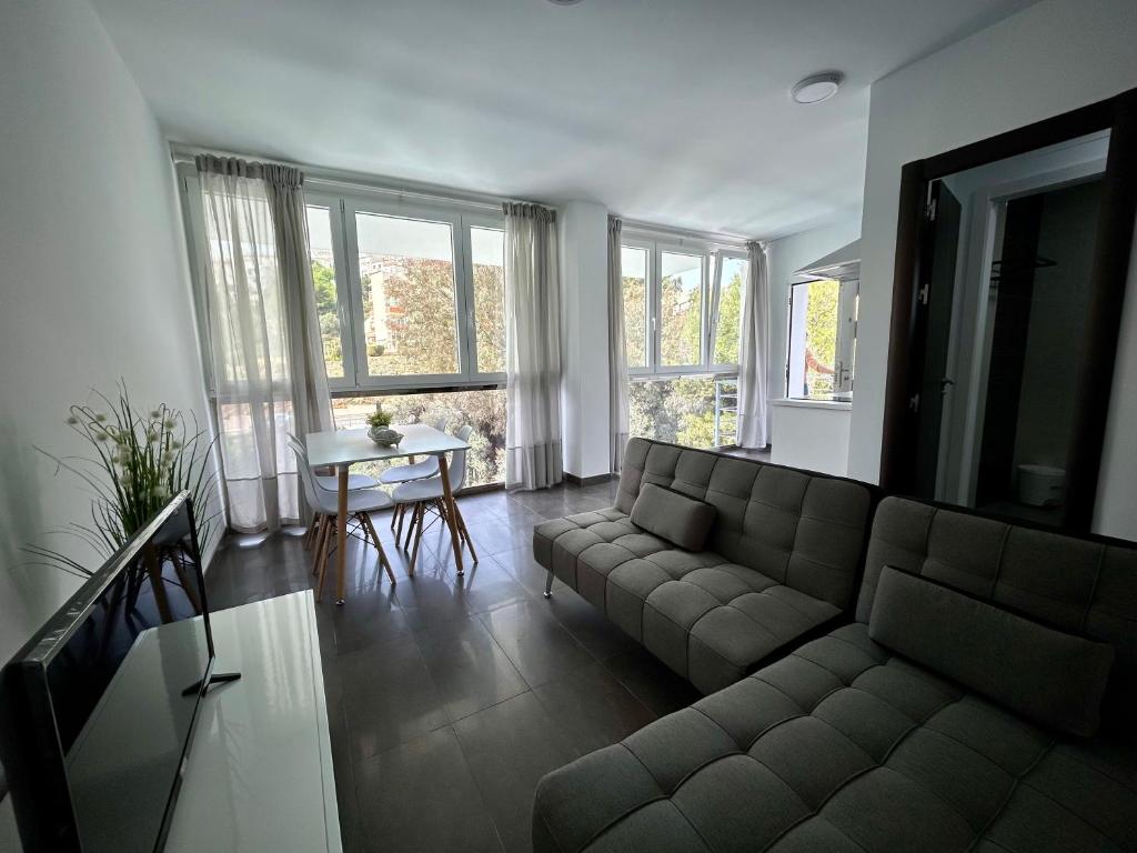 a living room with a couch and a table at Apartamento Verdial 2 in Cala del Moral