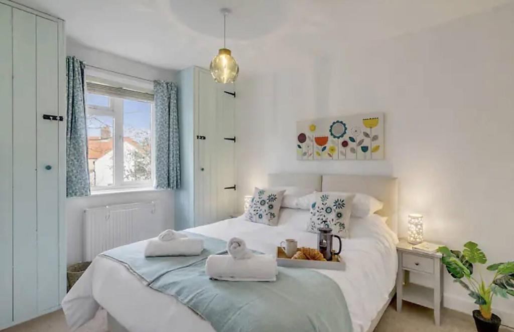 a bedroom with a bed with two towels on it at Turnstone Retreat - Parking in Sheringham