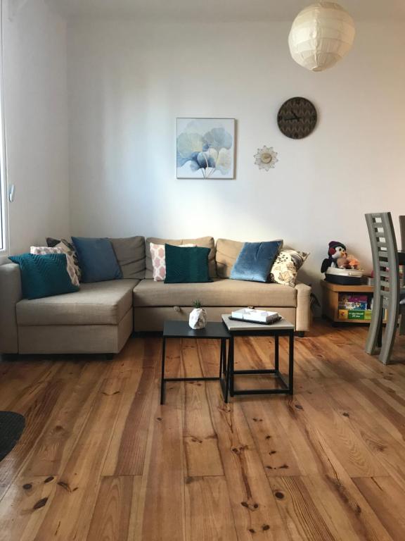 a living room with a couch and a table at Appartement à côté de la Gare in Hendaye