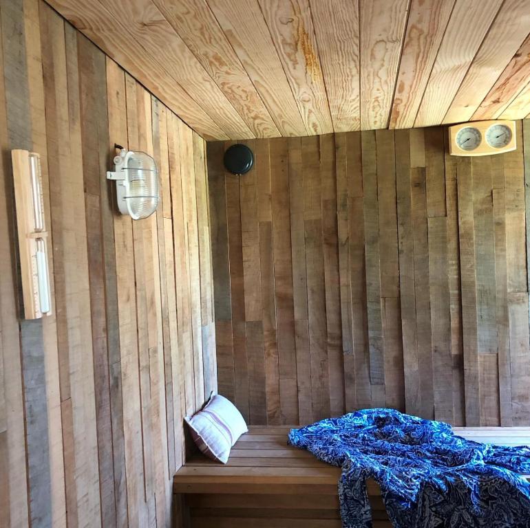 ein Zimmer mit einer Holzwand und einem Bett in einer Sauna in der Unterkunft Gîte la Luchette - petit village médiéval de la Somme in Lucheux
