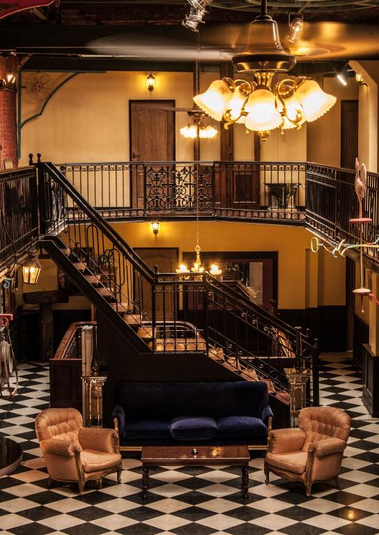 a living room with a couch and a staircase at DEL900 Hotel Boutique in Buenos Aires