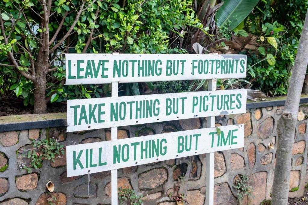 a bunch of street signs on a stone wall at Moments Lodge in Lilongwe