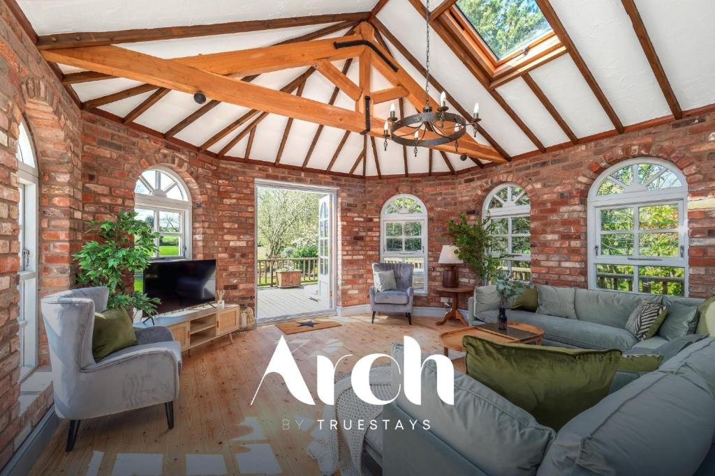 a living room with a brick wall at NEW - Country House, Staffordshire in Abbots Bromley