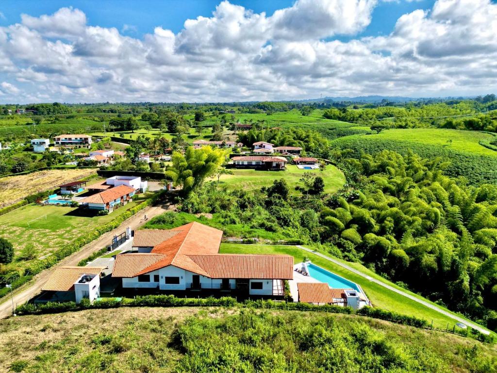 an aerial view of a house on a hill with a pool at Finca Mutatá in Montenegro