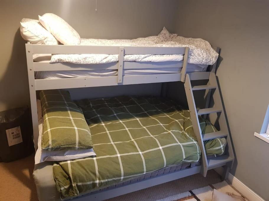 a couple of bunk beds in a room at Just the Splott! Sleeps 6, 8 mins to Stadium. in Cardiff
