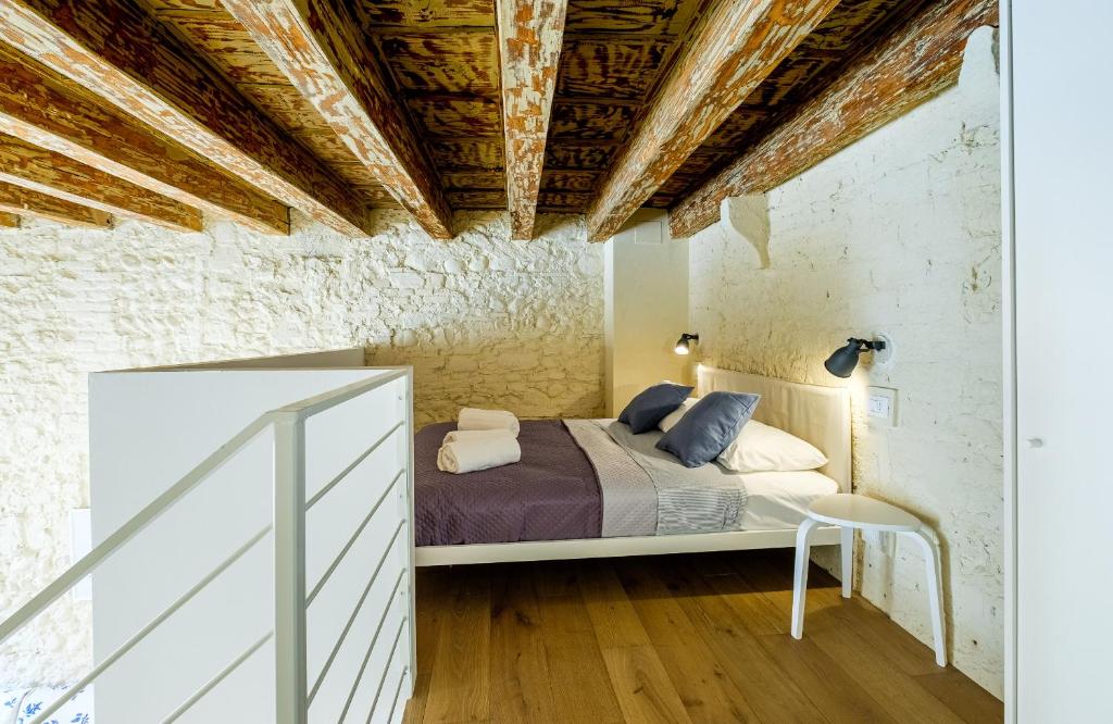 ein Schlafzimmer mit einem Bett und einer Holzdecke in der Unterkunft PAO Apartment - Veronetta 1 in Verona