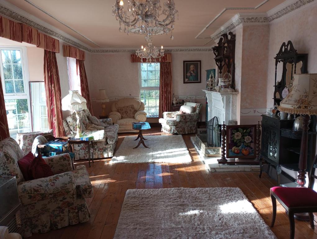 a living room with furniture and a chandelier at Hardwood Hall in Kinnegad
