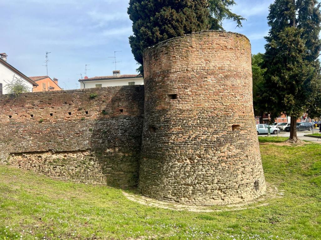 a tall brick wall with a tree behind it at IL TORRIONE in Castel Bolognese