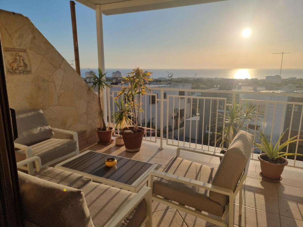 a balcony with a table and chairs on a balcony at MEDITERRANEAN VALLEY in Paphos City