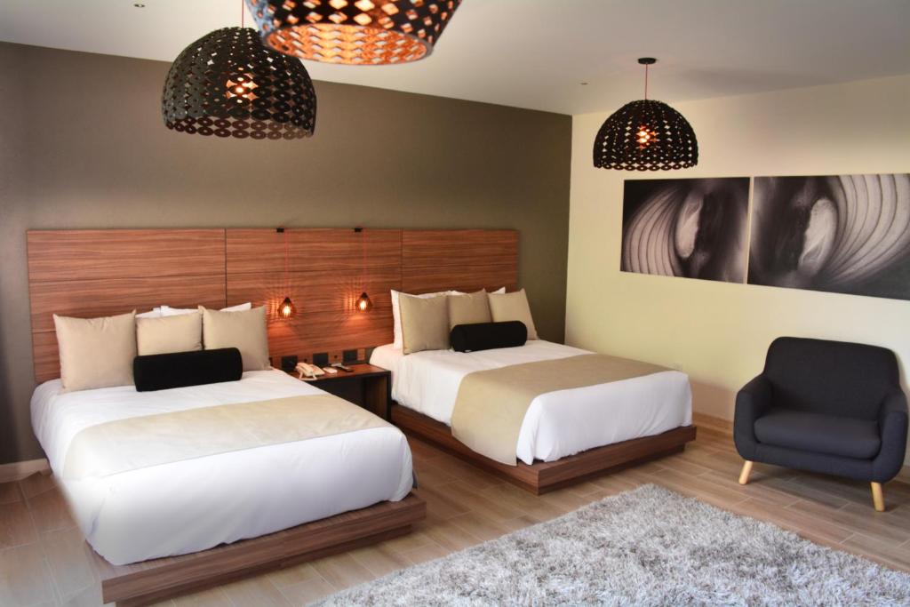 Postel nebo postele na pokoji v ubytování Ilo Rojo Hotel Boutique