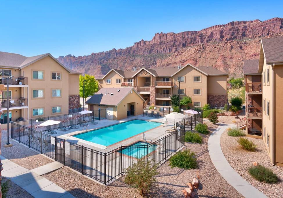 an aerial view of a apartment complex with a swimming pool at 6E Family Friendly RedCliff Condo, POOL & HOT TUB in Moab