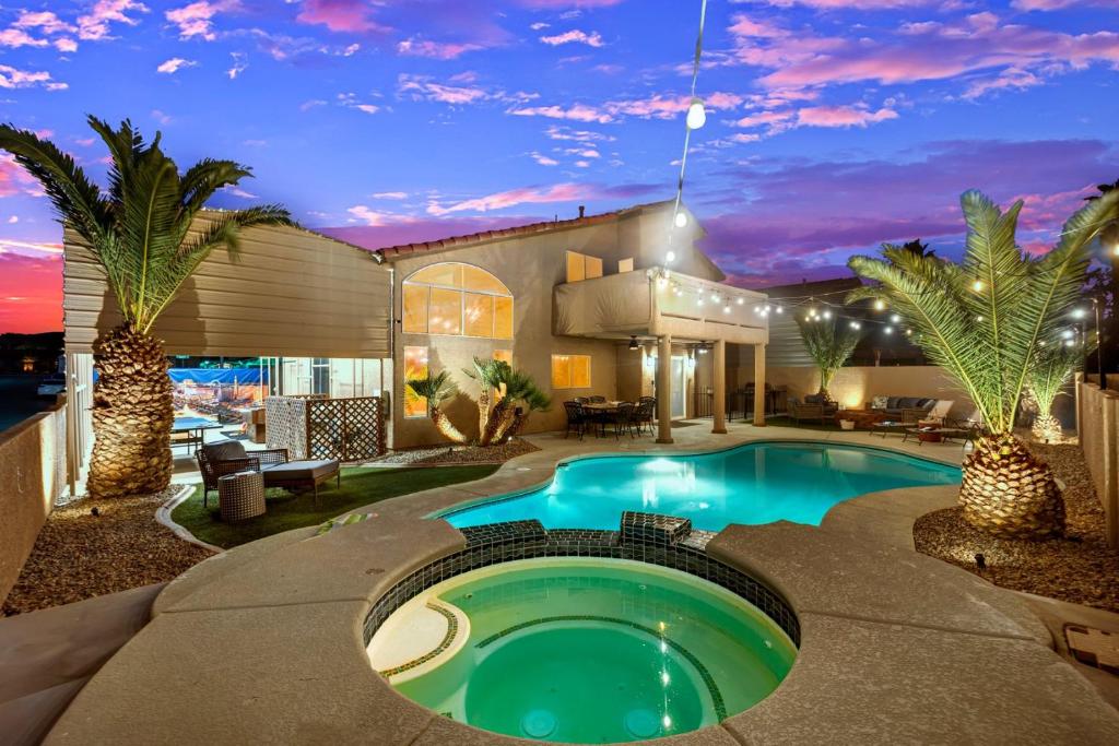 a pool in the backyard of a house at night at Heritage Haven Villa in Las Vegas