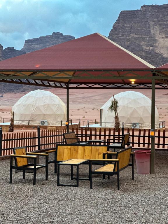 a group of tables and chairs under a tent at RUM CHEERFUL lUXURY CAMP in Wadi Rum