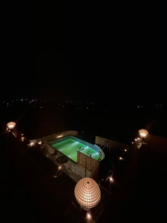 an overhead view of a swimming pool at night at Lost &Found in Bhopal