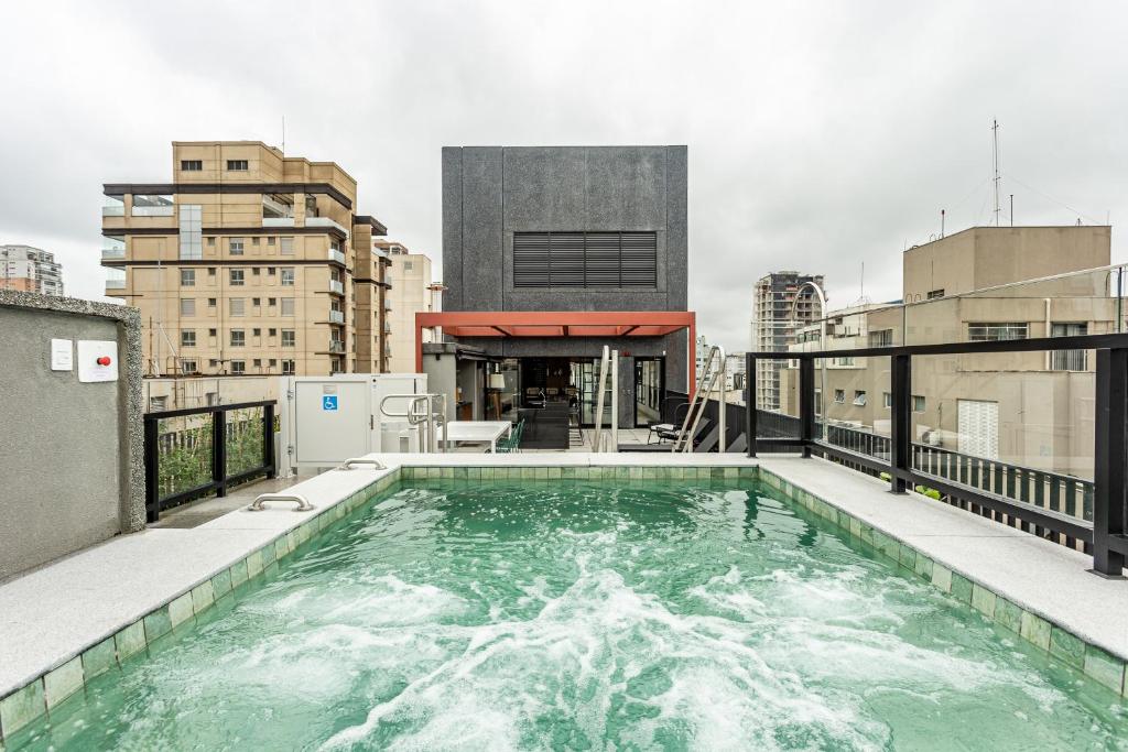 a swimming pool on the roof of a building at Charlie Sabiá Ibirapuera in Sao Paulo