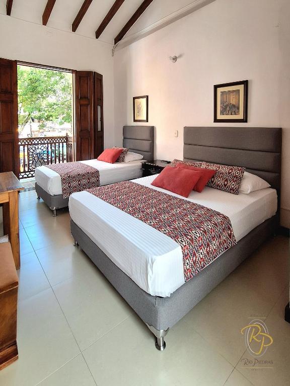 Postel nebo postele na pokoji v ubytování Hotel Rio Piedras